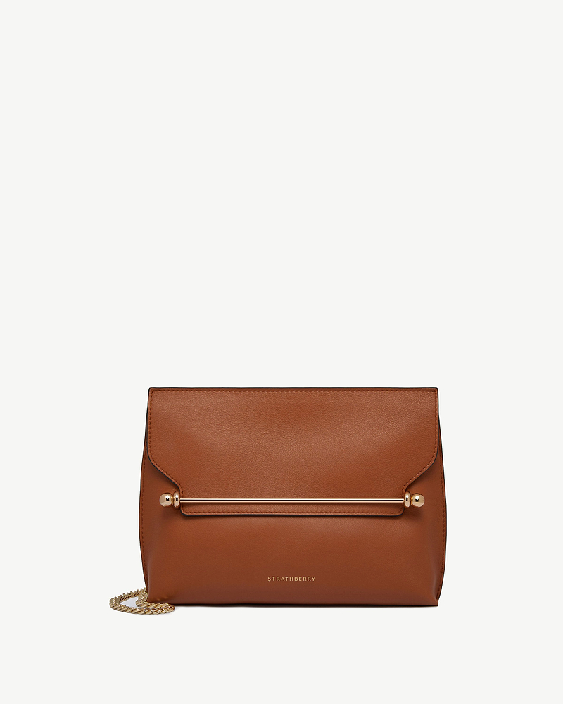 Chestnut Strathberry Stylist bag with gold bar detail and chain strap.