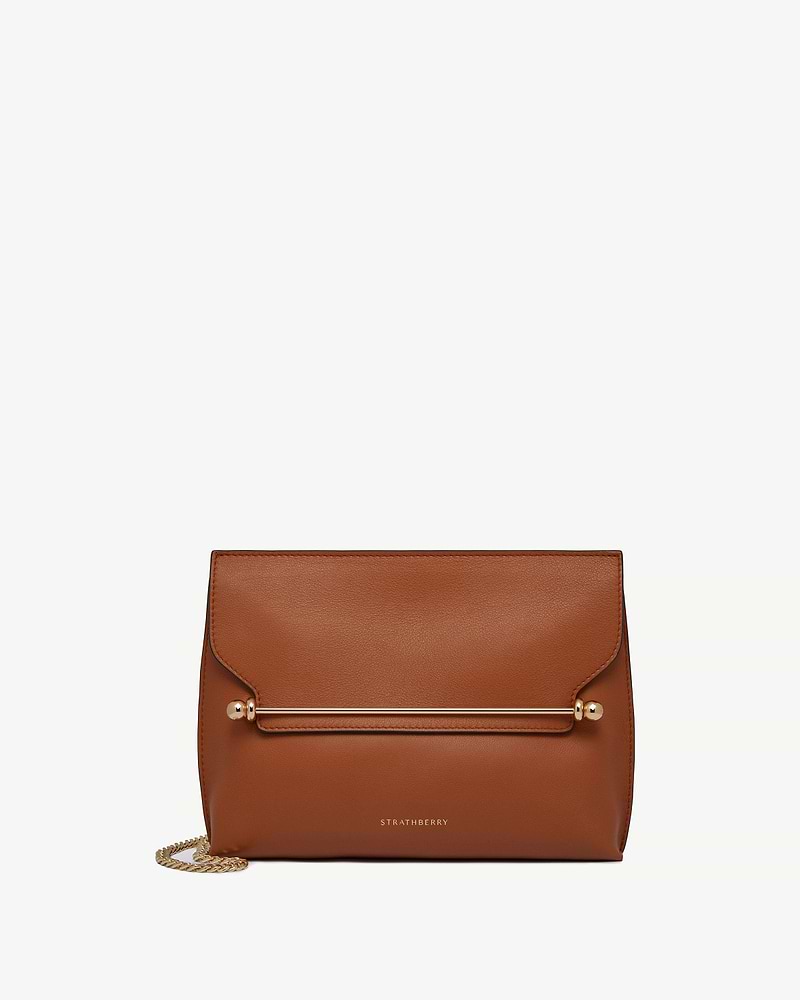 Chestnut Strathberry Stylist bag with gold bar detail and chain strap.