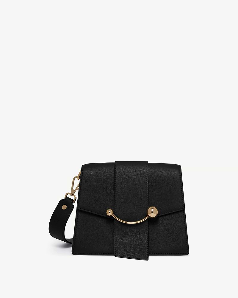 Black structured box bag with curved gold bar and detachable wide shoulder strap.