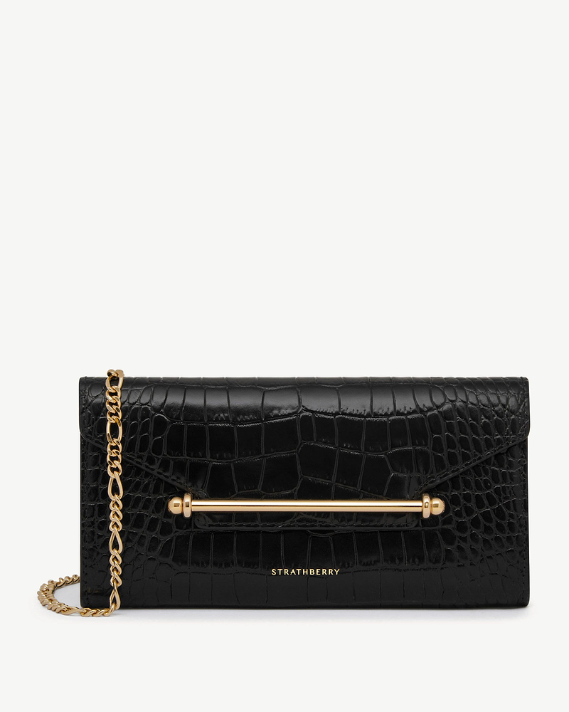 Black croc-effect Multrees chain wallet with gold bar and chain, Strathberry logo.