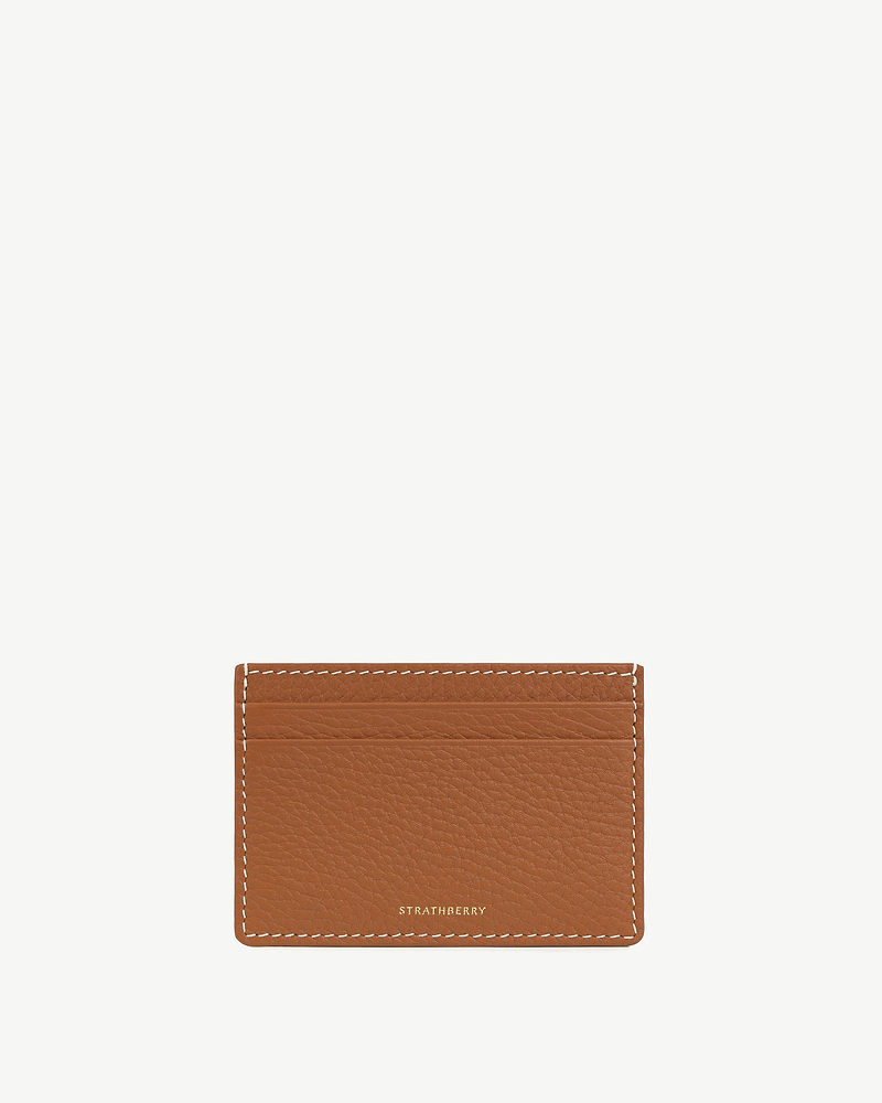 Tan leather cardholder with vanilla stitching and small gold Strathberry logo.