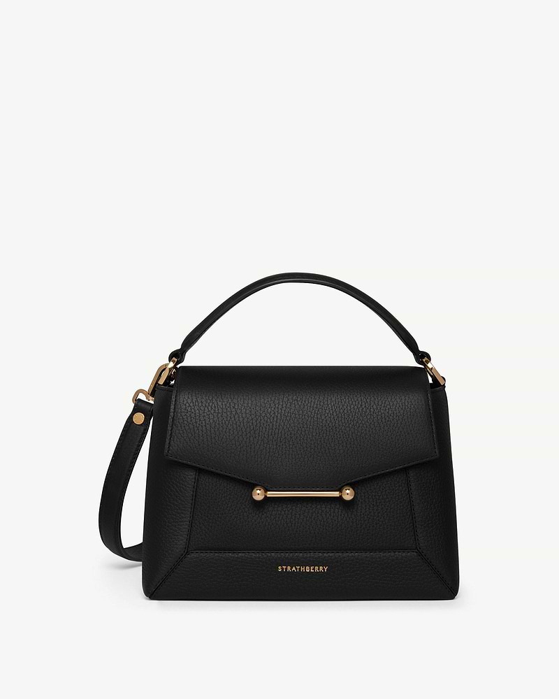 Black Strathberry mosaic bag with top handle, detachable strap and gold bar.