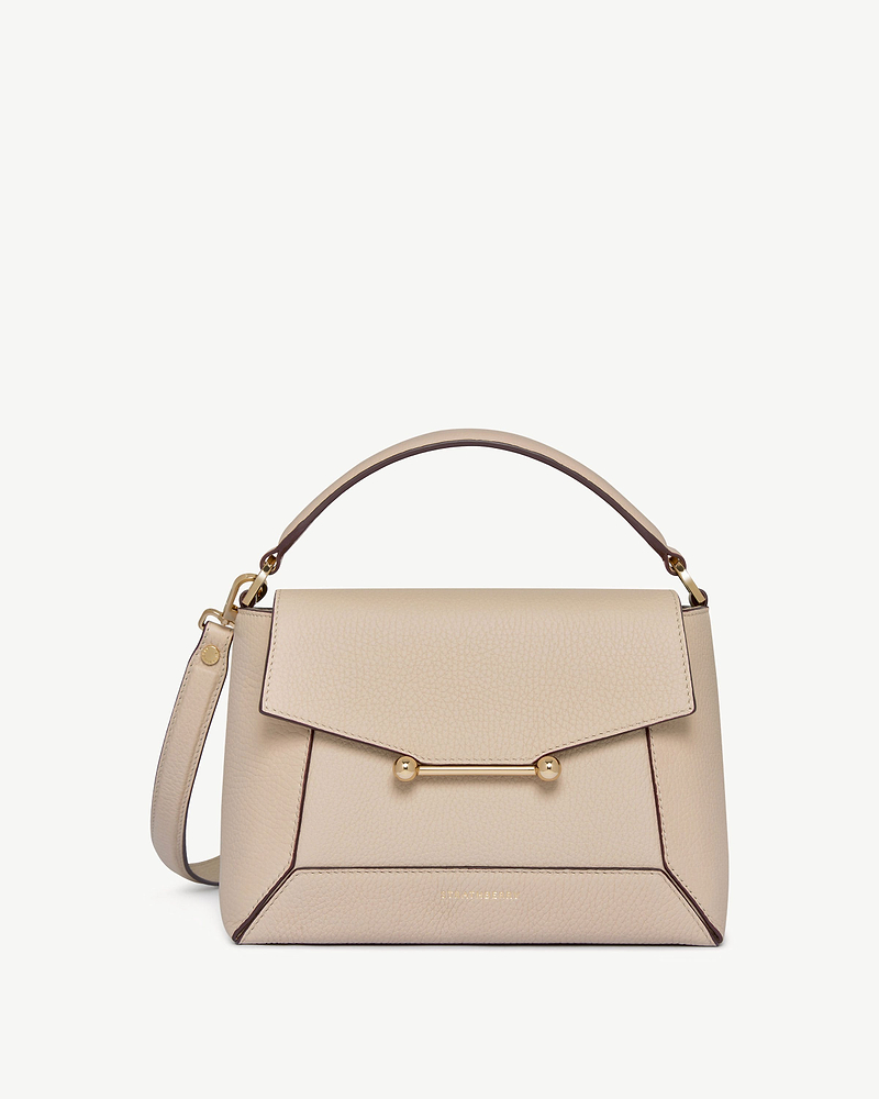 Strathberry Mosaic bag in oat leather with top handle and gold bar fastening.