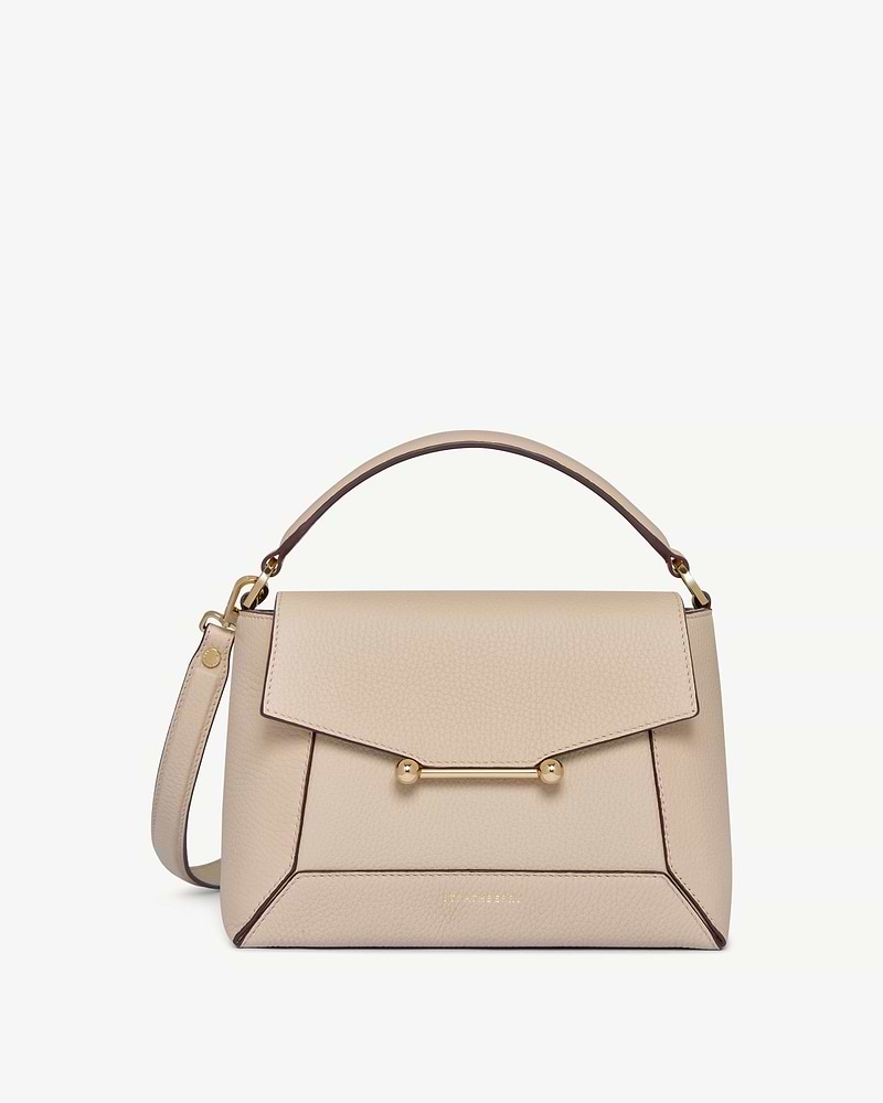 Strathberry Mosaic bag in oat leather with top handle and gold bar fastening.