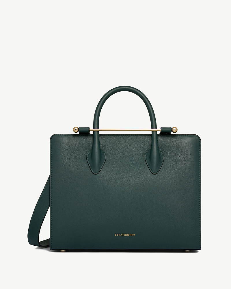 Bottle green Strathberry midi tote with top handles, shoulder strap and gold bar detail.