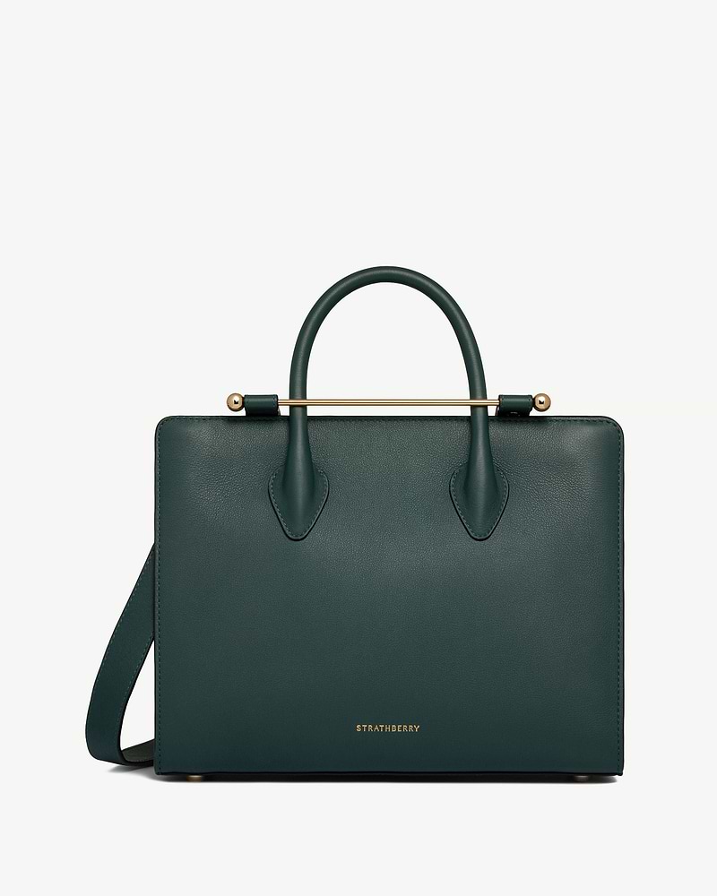Bottle green Strathberry midi tote with top handles, shoulder strap and gold bar detail.