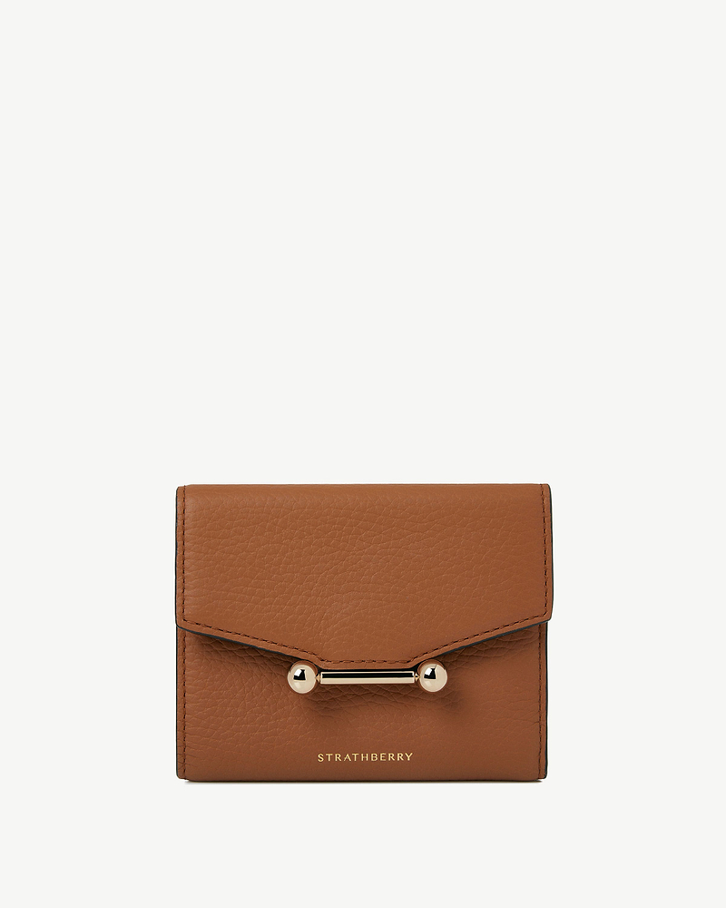 Tan mosaic trifold wallet with gold bar closure and Strathberry wordmark.