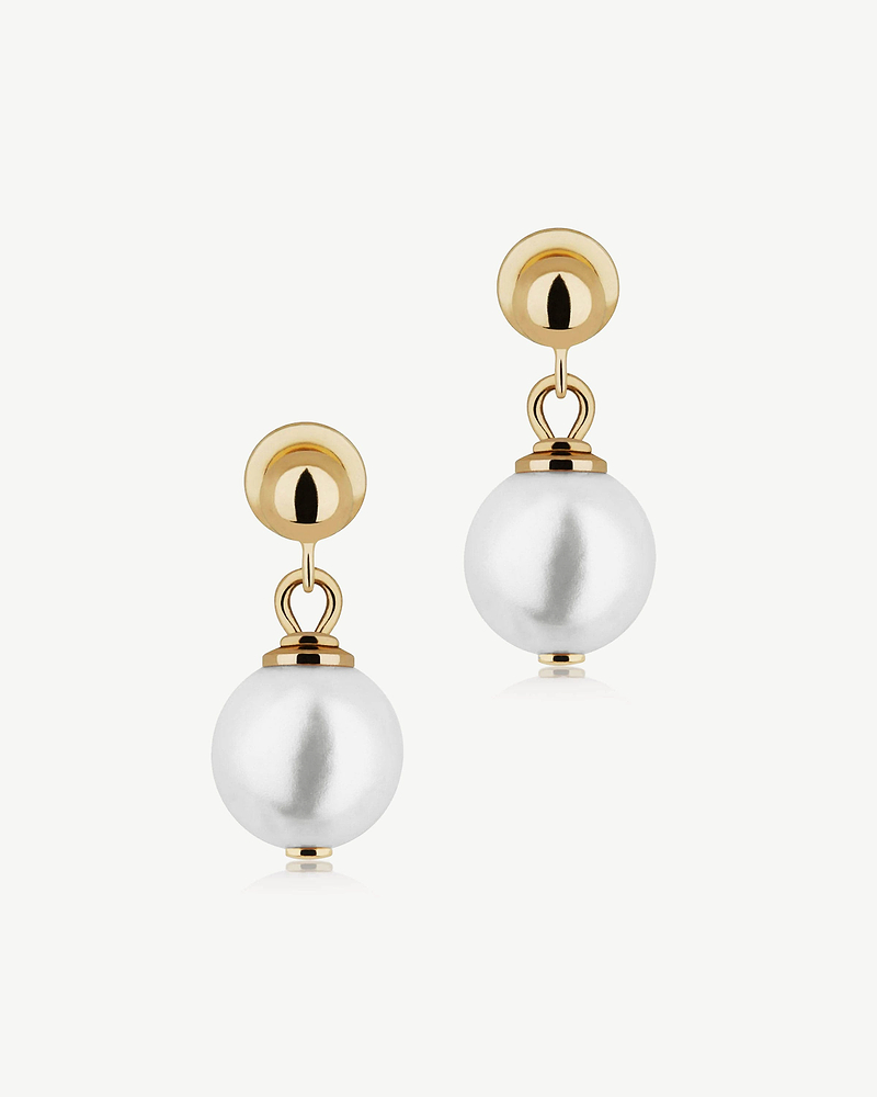 Pair of drop pearl earrings with 24 carat gold-gilded studs on white background.