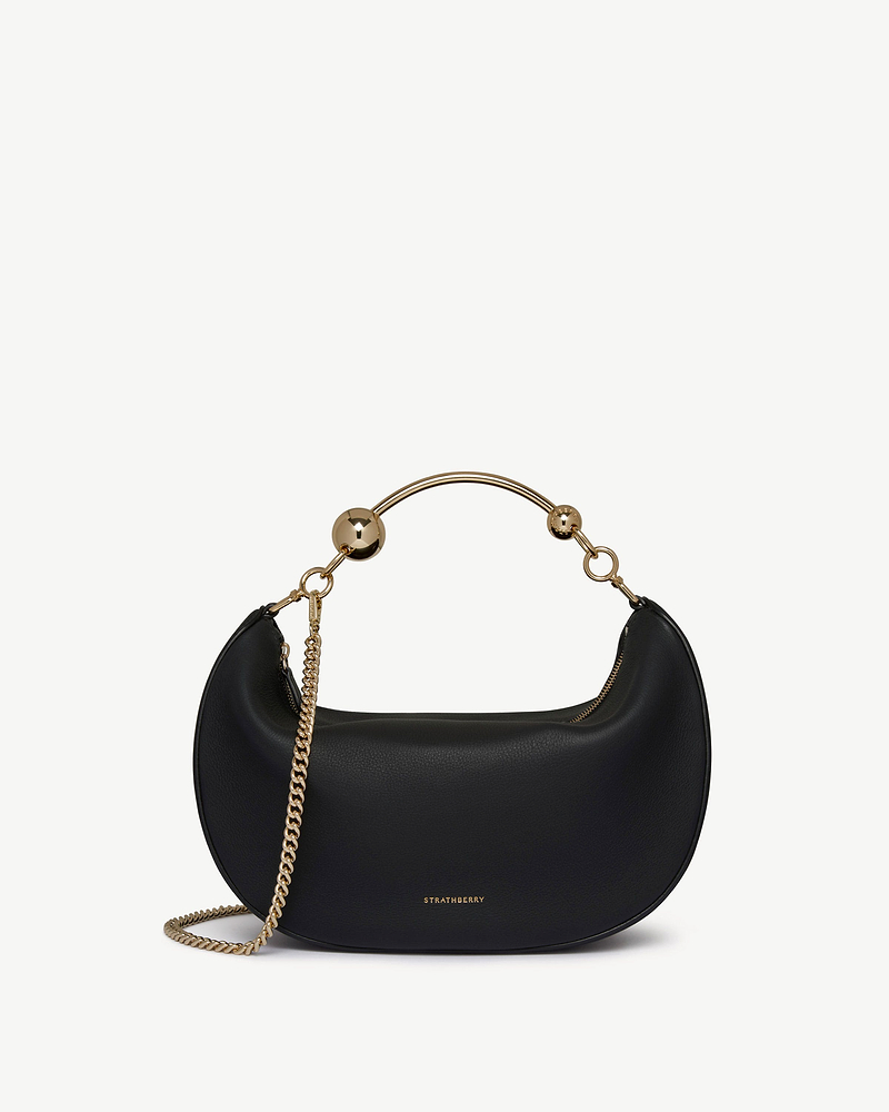 Black Crescent Moon bag with gold ball handle, chain strap and Strathberry logo.
