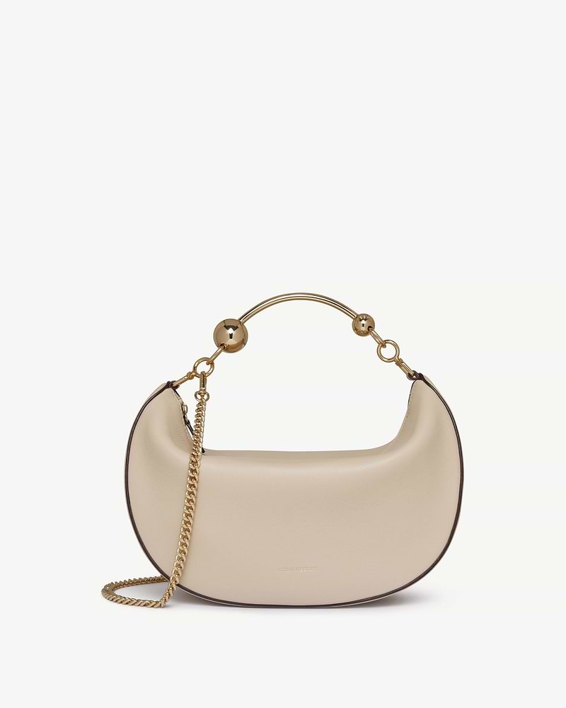 Oat crescent-shaped leather bag with gold chain strap and top handle.