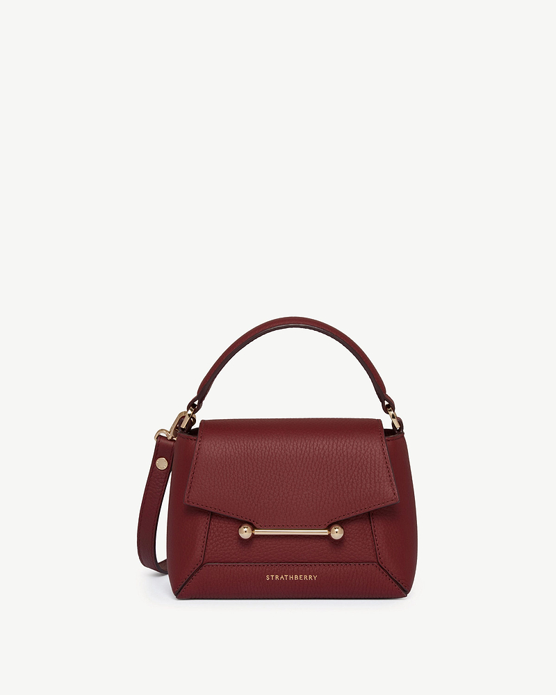 Oxblood Strathberry Mosaic Nano handbag with top handle and gold bar.