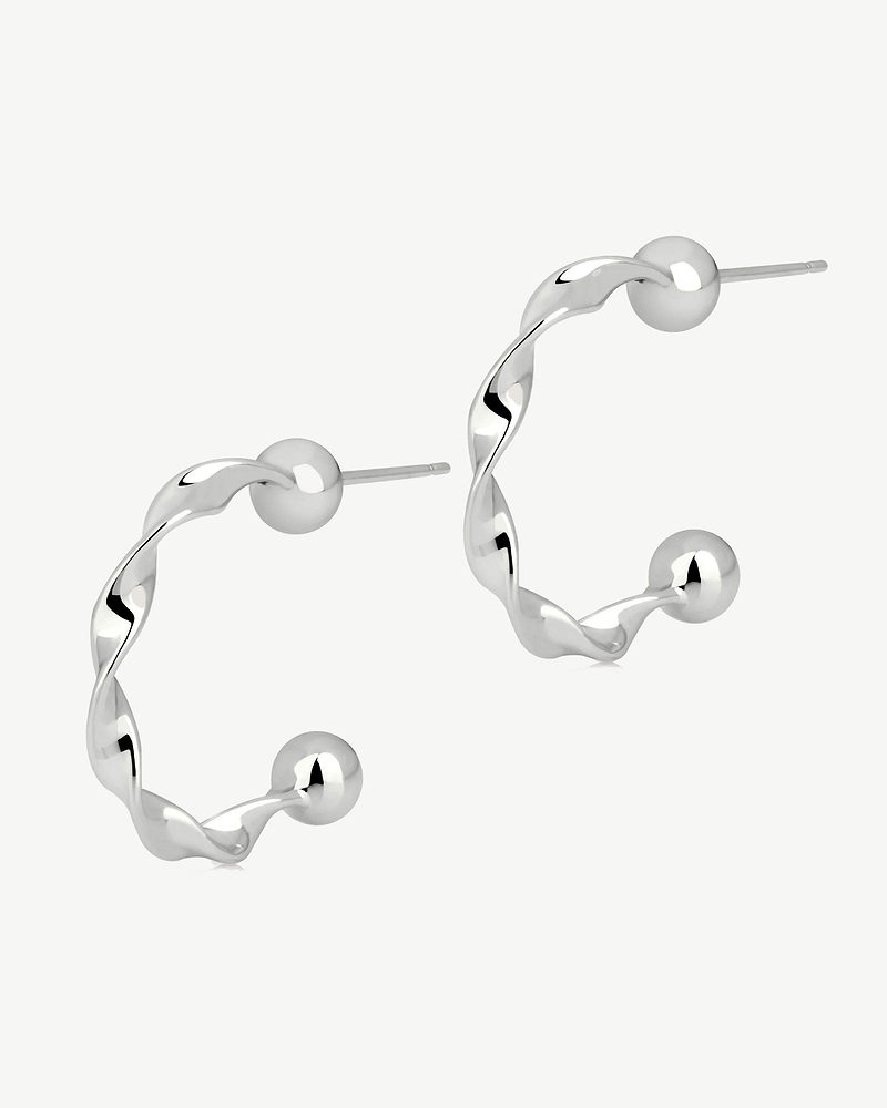 Pair of crescent twisted hoop earrings in sterling silver with ball ends.