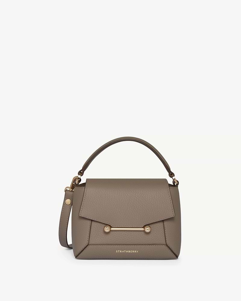 Strathberry Mosaic Nano taupe leather top-handle bag with gold bar detail.