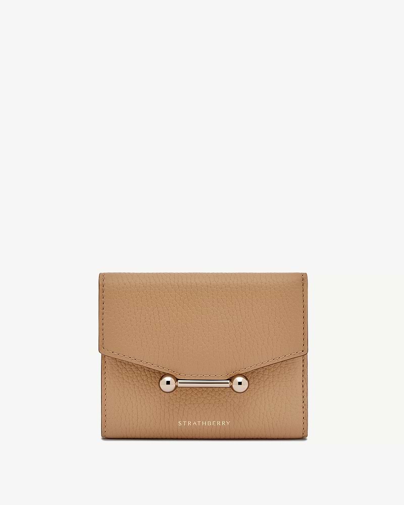Strathberry mosaic trifold wallet in caramel grained leather with bar fastening.