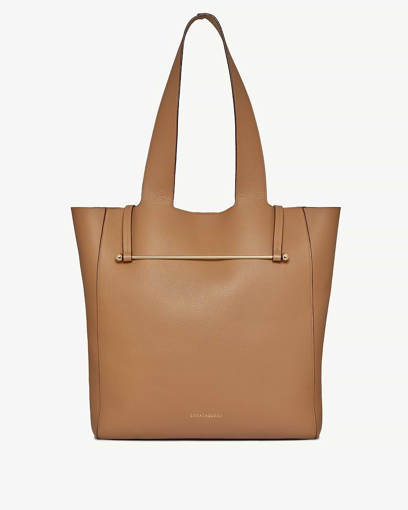 Caramel leather tote bag with gold bar detail and Strathberry logo