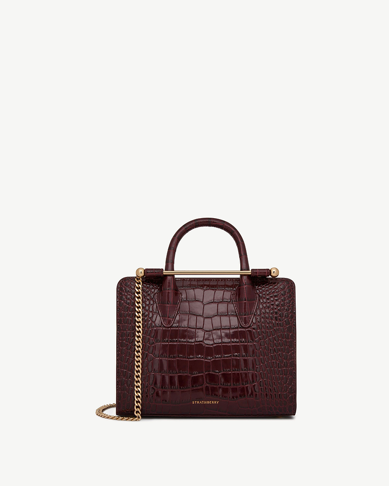 Burgundy croc mini tote with gold bar handle and chain strap, Strathberry logo