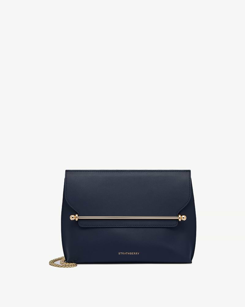 Strathberry Stylist bag in marine blue with gold bar and chain