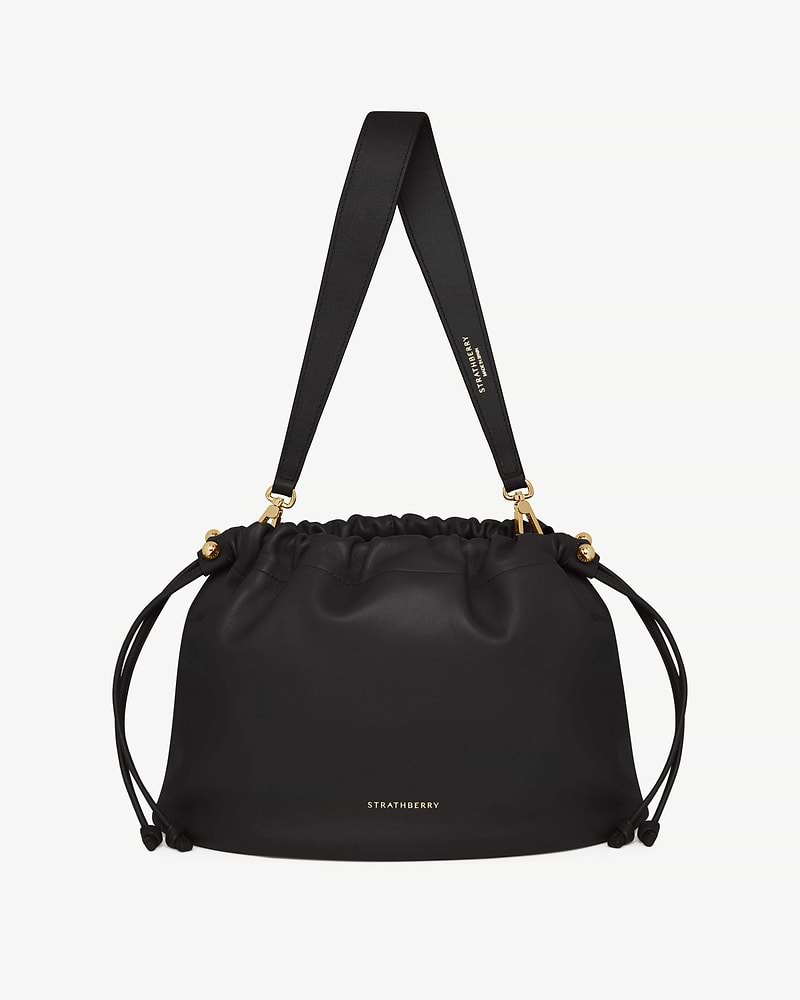 Black Strathberry Charlotte Midi drawstring bag with wide shoulder strap and gold hardware