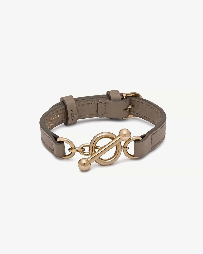 Taupe leather Kite bracelet with gold toggle clasp on white background.