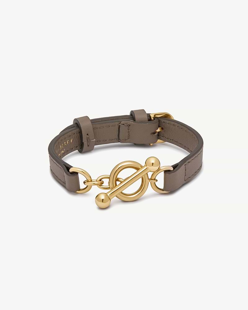 Taupe leather bracelet with gold-tone toggle ring and bar fastening.