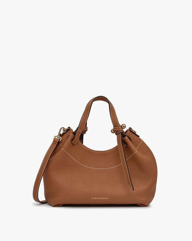 Tan Barra Mini leather bag with top handles, shoulder strap and Strathberry logo.