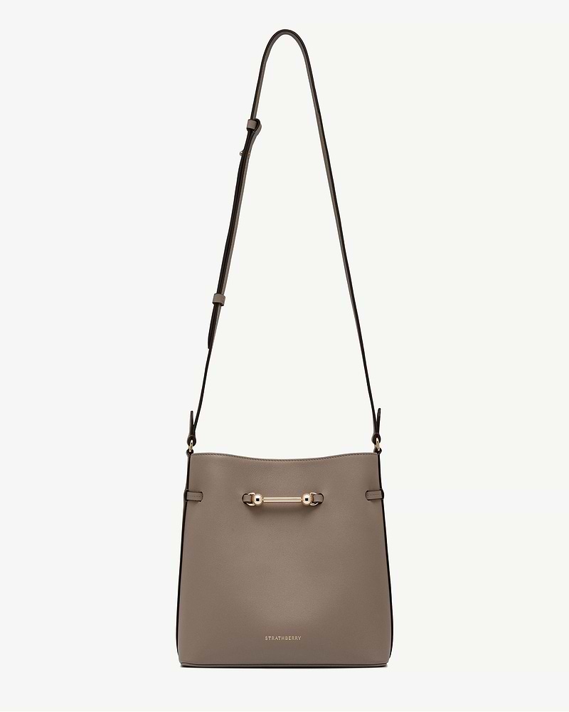 Taupe Corda bucket bag with adjustable shoulder strap and gold Strathberry logo