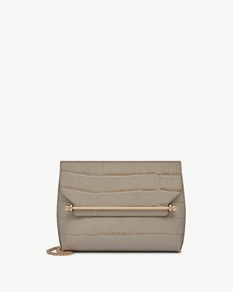 Croc-embossed Stylist bag with gold bar hardware, chain strap, and Strathberry logo.