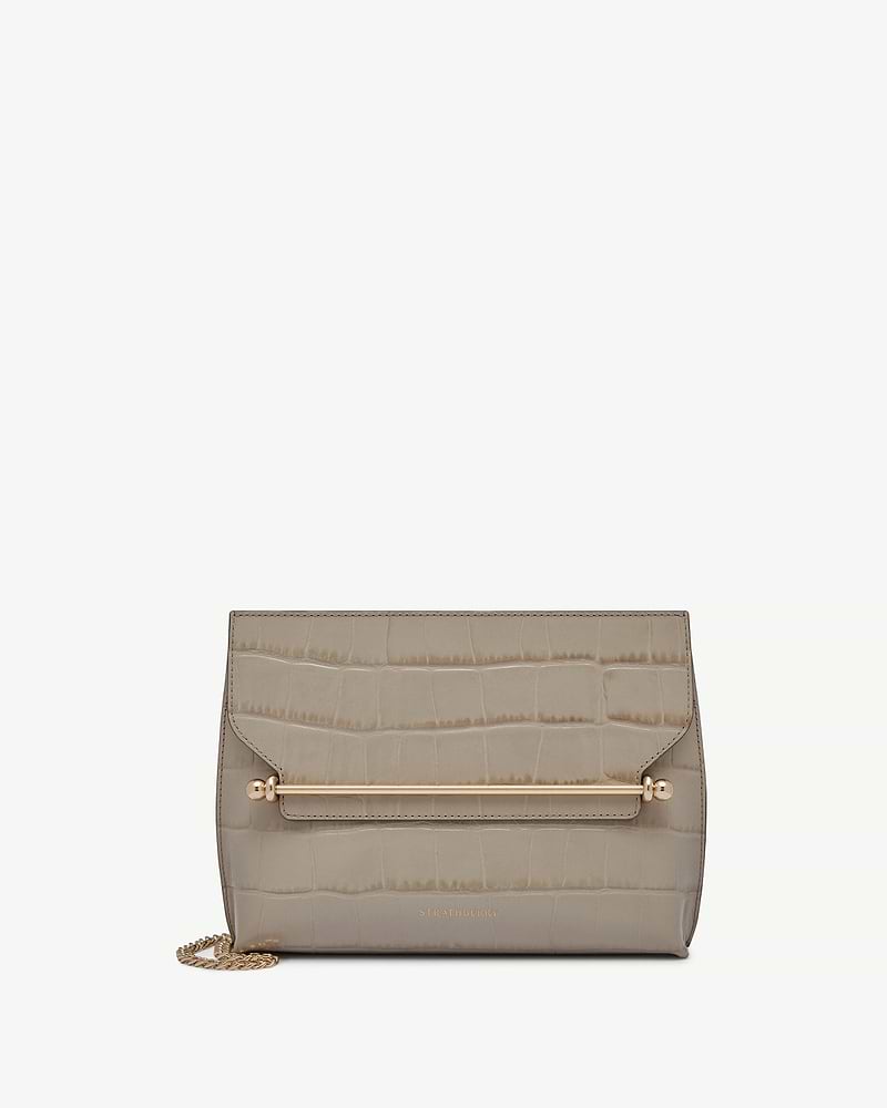 Croc-embossed Stylist bag with gold bar hardware, chain strap, and Strathberry logo.