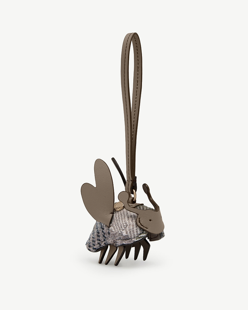 Tweed and leather bag charm with loop strap and gold tone stud.