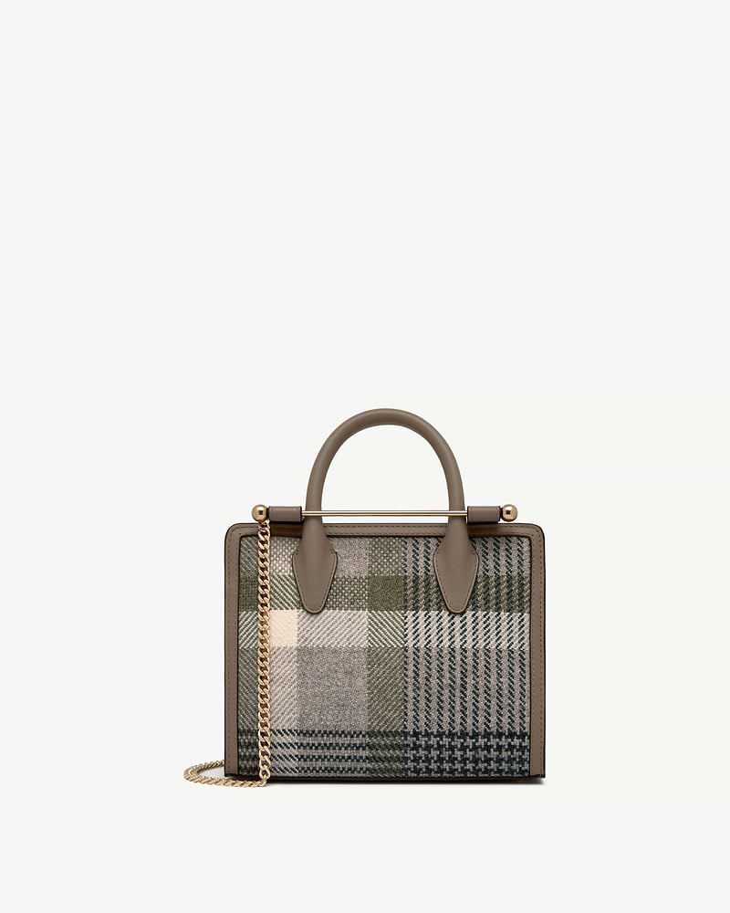 Mini tote with top handles, taupe leather trim and green tartan fabric, gold chain strap.
