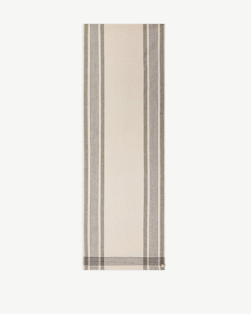 Beige tartan cotton-linen table runner with vertical dark stripes and Strathberry tag.