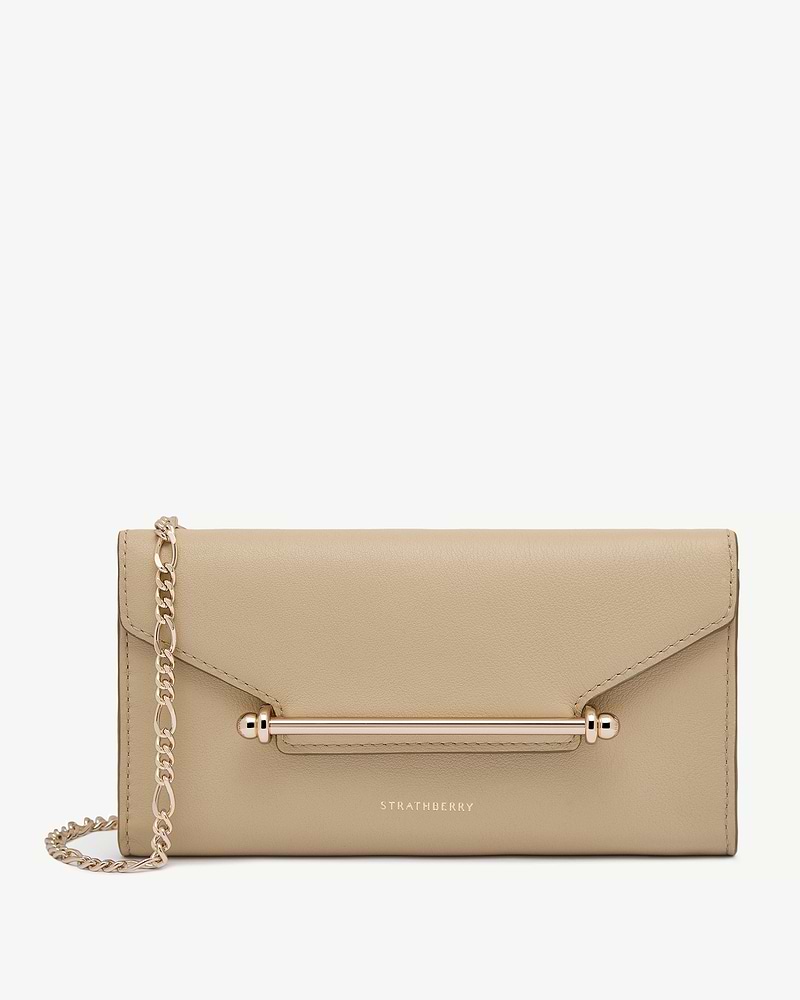 Strathberry chain wallet in sand with gold bar and chain.