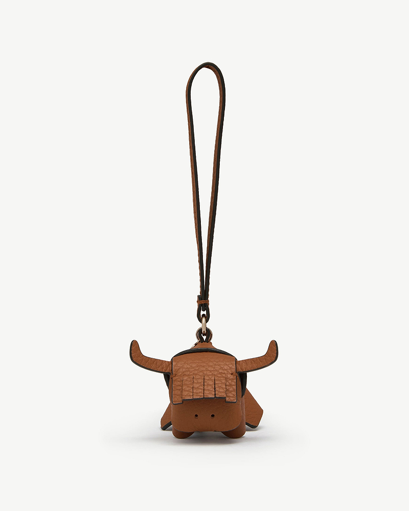 Highland cow tan leather bag charm with long strap, front view