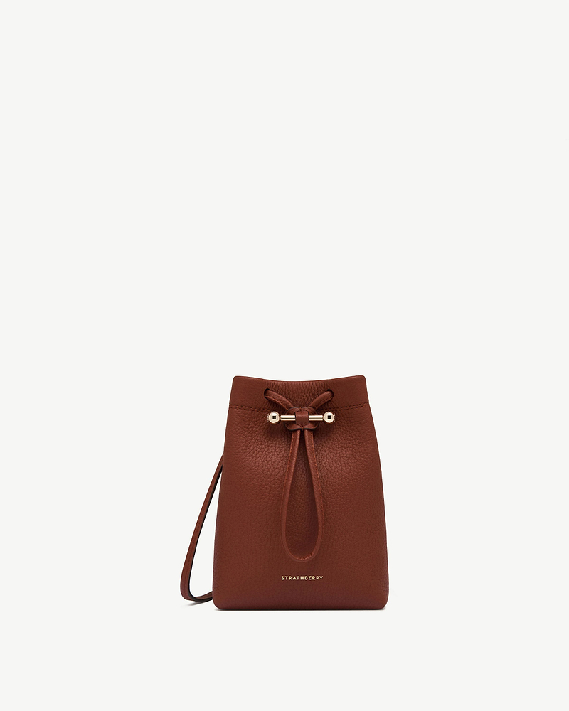 Walnut leather Osette Midi Pouch with drawstring top and Strathberry logo.