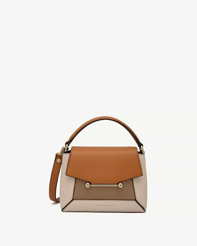 Tricolour oat, honey and clay leather top-handle bag with gold bar closure, Strathberry logo.