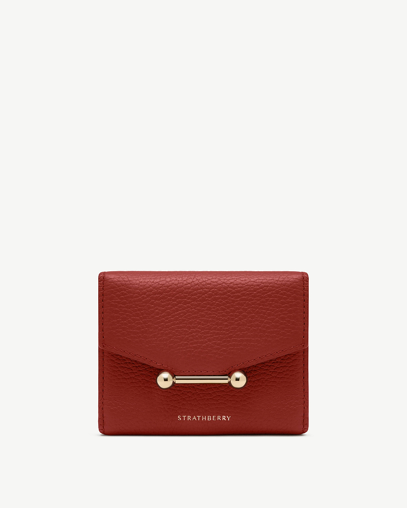 Levanto red mosaic trifold wallet with gold bar clasp and Strathberry logo.