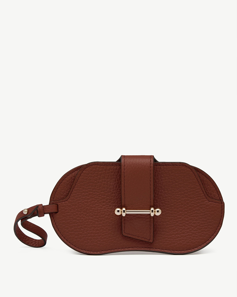 Walnut pebbled leather sunglasses case with wrist strap and gold bar fastening.