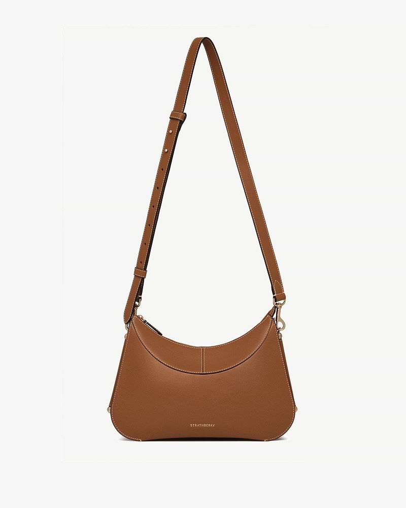 Tan Nest shoulder bag with adjustable strap and Strathberry logo at base.