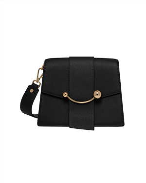 Black box crescent bag with front vertical tab, gold crescent bar, and detachable shoulder strap.