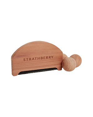 Wooden Strathberry garment brush with two round handles and metal teeth.