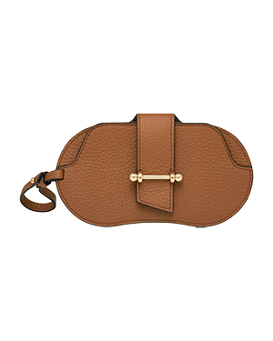Tan pebbled leather sunglasses case with gold-tone bar clasp and wrist strap.