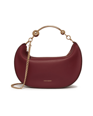 Strathberry crescent moon bag in oxblood leather with gold chain strap.