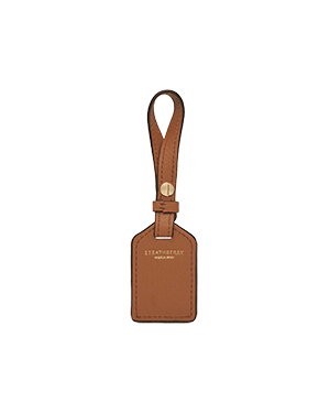 Tan leather tag with loop strap and gold Strathberry logo.