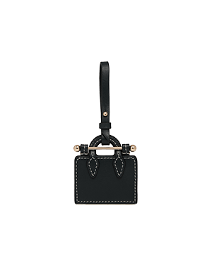 Black leather tote charm with contrast stitching, gold hardware, and hanging strap.