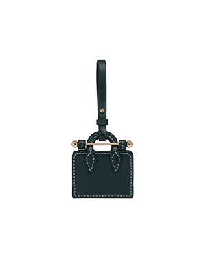 Bottle green tote charm with hanging strap and contrast white stitching.