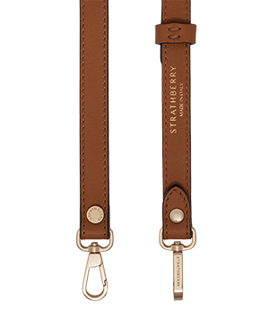 Thin adjustable chestnut leather strap with gold hardware and Strathberry logo