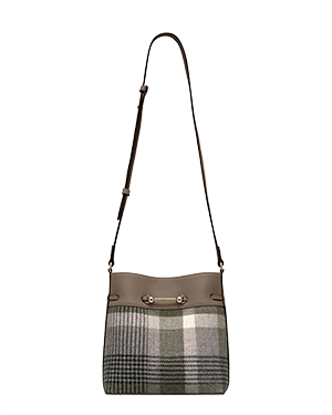 Taupe leather-trim bucket bag with tartan panel and long adjustable shoulder strap.