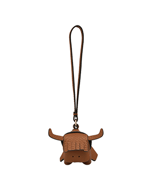 Tan highland cow leather bag charm with long loop strap and stitched fringe.