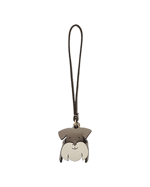Grey and cream dog-shaped bag charm with long dark brown strap and metal clasp.