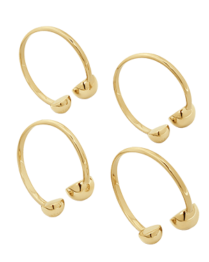Four light gold napkin holders with rounded end caps on white background.